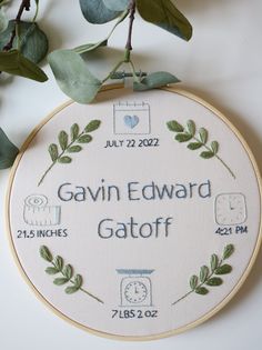 a cross stitch pattern with the words gavin edward gafff on it, surrounded by greenery