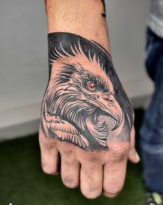 a man's hand with an eagle tattoo on it