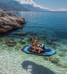 two women on a jet ski in clear water