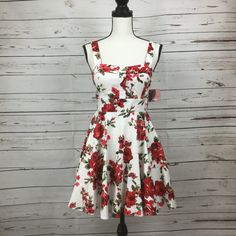 Ixia Junior’s Retro Style Fit & Flare White Dress With Red Floral Print. Tie At Waist, Zip Closure At Back. Chest Area Is Lined With Built In Bra Pads. Made In Usa. Size M Junior New With Tag. Approx. Measurements: Chest 16.5" Waist 14" Length 32" #7 Red A-line Floral Dress For Summer, Red Fit And Flare Summer Dress, Fitted Red Floral Dress For Spring, Fitted Red Floral Dress For Summer, Red A-line Floral Summer Dress, Red Fitted Floral Dress For Garden Party, White Cotton Fit And Flare Mini Dress, A-line Mini Dress For Spring Holiday, Red Fitted Mini Dress For Garden Party