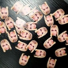 a bunch of hair clips that have been cut into people's faces on them