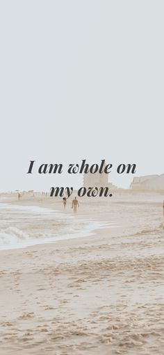 two people walking on the beach with an ocean in the background and a quote above them that reads, i am whole on my own