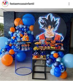 balloons and decorations are on display in front of a wall with an image of gohan