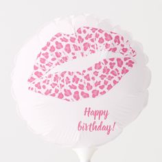 a white balloon with pink leopard print on it and the words happy birthday written in large letters