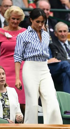 two women standing next to each other at a tennis match