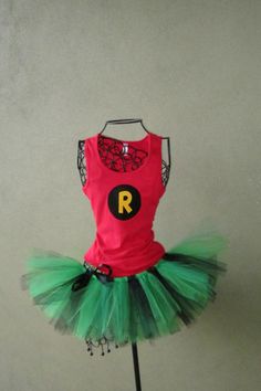 a red shirt and green tutu skirt on a mannequin