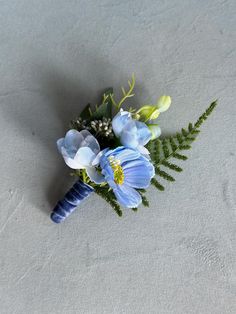 a bouquet of blue flowers sitting on top of a table