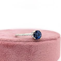 This beautiful ring features a 1.20 carat round Blue Sapphire gemstone with natural earth mined diamonds set in solid 14K gold. This Blue Sapphire makes a lovely September birthstone gift for your loved ones! This ring is made with solid 14K Gold and natural Earth mined SI / G-H diamonds. As listed, this ring is ready to ship. If you're interested in purchasing this setting with a different center stone please message us! Diamond Birthstone Ring With Round Cut For Proposal, Diamond Ring With Brilliant Cut Sapphire In Round Shape, Sapphire Diamond Ring With Brilliant Cut, Proposal Diamond Ring With Brilliant Cut Sapphire, Brilliant Cut Sapphire Diamond Ring, Proposal Sapphire Diamond Ring With Brilliant Cut, White Gold Moissanite Sapphire Ring, White Gold Round Cut Moissanite Sapphire Ring, Solitaire Sapphire Ring With Diamond For Proposal