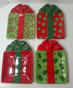 three green and red plates with presents on them