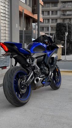 a blue and black motorcycle parked on the street