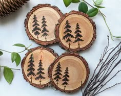 four pieces of wood with trees painted on them