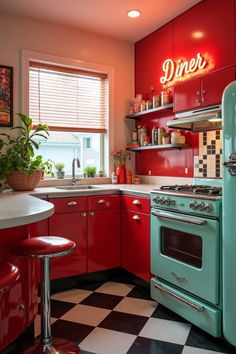 a kitchen with red cabinets and black and white checkered flooring, an old fashioned gas stove