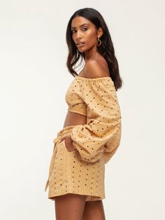 Step into style with our Naka midriff top, boasting chic and exaggerated sleeves. Crafted for comfort with elasticized features throughout, this crop off-the-shoulder piece is perfect for pairing with our Leer Nar Pants, ensuring you're ready for your next destination in effortless elegance. Handcrafted in our small atelier in Dakar, Senegal, this top blends intricate embroidery with sustainable 100% cotton for a timeless addition to your wardrobe. Crop off-the-shoulder top Elasticized sleeves E Trendy Off-shoulder Crop Top For Vacation, Casual Cropped Off-shoulder Top For Day Out, Chic Off-shoulder Crop Top For Summer, Summer Crop Top With Blouson Sleeves, Chic Cropped Crop Top For Vacation, Chic Crop Top With Blouson Sleeves, Summer Off-shoulder Top With Blouson Sleeves, Off-shoulder Crop Top For Spring Day Out, Summer Long Sleeve Off-shoulder Top With Blouson Sleeves