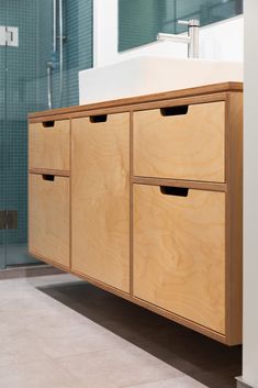 a bathroom with a sink and wooden cabinets