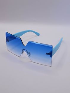 Embrace vibrant style with the Linda Clay Unisex Retro Sky Blue Colored Sunglasses! These chic shades are designed to elevate your look while providing essential eye protection. Key Features: Rimless Design: Sleek and modern, ensuring a lightweight feel and minimal obstruction. Oversized Square Frame: Offers ample coverage for your face, making a bold fashion statement. UV Protection: Safeguard your eyes from harmful rays without sacrificing style. Eye-Catching Sky Blue Color: Perfect for adding Blue Rimless Sunglasses With Uva Protection, Blue Plastic Shield Sunglasses For The Beach, Blue Plastic Shield Sunglasses For Beach, Blue Plastic Sunglasses With Uva Protection, Blue Rimless Sunglasses With Uv Protection, Blue Rectangular Sunglasses For Summer, Blue Plastic Shield Sunglasses For Summer, Blue Plastic Sunglasses For Summer, Light Blue Sunglasses With Uv Protection For Beach