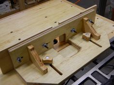 a wooden workbench with several pieces of wood in the shape of an instrument