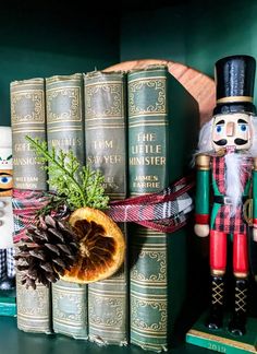 a nutcracker and some books on a shelf