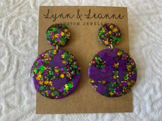 Welcome to my shop.  If you love glitter you have come to the right place. These Mardi Gras resin earrings are amazingly light weight and will make a statement with any outfit.  It's like a party on your ears.    I will normally ship in 1-2 days (not including holidays and weekends) All of my earrings are hand poured using resin, glitter, mica powders, alcohol inks.  Earrings are finished with findings containing brass and stainless steel that are hypoallergenic and nickel free. Every pair of earrings will be slightly unique and could have minor flaws since they are hand poured. Purple Glitter Earrings For Gift, Bling Gifts, Resin Glitter, Teachers Gifts, Alcohol Inks, Gifts For Teachers, Mica Powder, Resin Earrings, Earrings Dangle