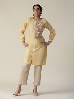 Featuring our light yellow cord set. Comes with an ankle length straight trouser pant(cottn satin), and a balloon sleeve knee length cotton kurti with a unique jute patch decorated with sequin, stones, tassels, pearl and silver coins(sikka). Color : YELLOW Fabric : CHANDERI SILK Lining Material: Crepe Fit : RELAXED 7 days Delivery No of pieces: 2 Yellow Cotton Sets With Dori Work, Yellow Cord Set, Embroidered Silk Yellow Sets, Embroidered Yellow Silk Set, Yellow Semi-stitched Dola Silk Sets, Semi-stitched Yellow Cotton Silk Sets, Cord Set, Cotton Kurti, Straight Trousers