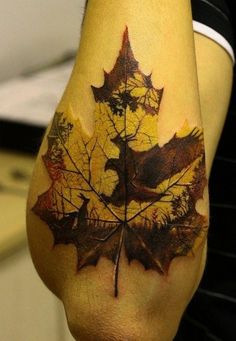 a person with a tattoo on their leg that has a leaf and birds on it