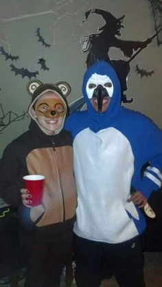 two people in animal costumes standing next to each other and holding cups with their mouths open