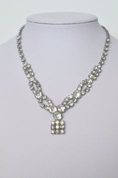 "Elegant vintage faceted sparkling clear rhinestone are arranged in the most beautiful way to make this necklace a statement piece. All stones are prong set in a silver toned rhodium plated finish setting with a hook for the clasp.  Measures 15\" long with 1.25\" drop.  It is In very nice vintage condition.  Great for a really special occasion! Shipping & Handling: We usually ship within 1 business day. If you have any questions about this item, please contact us for more details. I do offer int Tone Back, Statement Choker Necklace, Buddha Pendant, Wood Necklace, Lovely Necklace, Glass Necklace, Art Deco Style, Clear Rhinestones, Deco Style