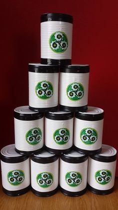 a stack of white and black containers sitting on top of a wooden table