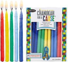 six colorful candles are in a box and one has a blue ribbon on the end