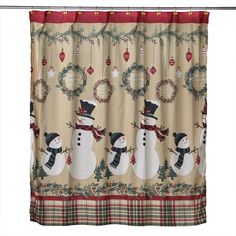 a shower curtain with a snowman and wreath design on the bottom, hanging from a metal rod