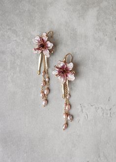 Inspired by the lush gardens and vistas of Italy, the Aria bohemian bridal earrings feature delicate flower motifs in a soft mauve tone, exuding an air of timeless elegance and sophistication. The real freshwater pearls add movement and grace, hinting at the way blossoms gentle sway in the Italian breeze. Perfect for adding a touch of romance to any ensemble, these earrings are the epitome of Italian charm and allure.  Light on the ears, the Aria suits a wide range of bridal hairstyles. Designed Bohemian Drop Earrings With Handmade Flowers, Bohemian Jewelry With Handmade Flowers Drop Earrings, Bohemian Flower Earrings With Flower Charm For Wedding, Nature-inspired Dangle Earrings For Weddings, Bohemian Wedding Flower Earrings With Flower Charm, Bohemian Wedding Jewelry With Flower Charm, Bohemian Flower Earrings For Wedding, Bohemian Pink Earrings For Weddings, Bohemian Purple Earrings For Wedding