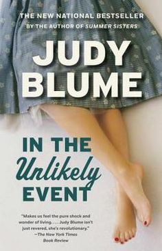 the cover of in the unlikely event by julia blume, with her feet propped up against the wall