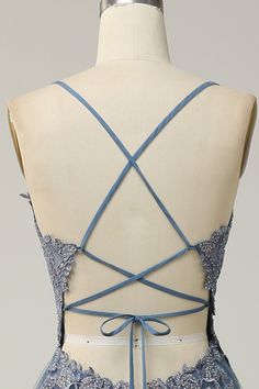 the back of a dress with blue laces on it and an open neckline