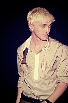 a man with blonde hair wearing a shirt and tie