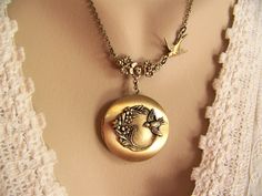 This softly brushed, satin finished bronze locket has beautiful decorative flowers and a tiny bird affixed to the face of the locket. A lovely silver flower connector holds the locket to a very delicate bronze chain enhanced with a flying bronze swallow. The 20" chain is closed with a bronze lobster claw clasp. The 32mm ( 1 1/4") round locket will surely be a beautiful accent to your wardrobe. The locket opens to reveal a compartment to hold keepsakes, notes, wishes, photographs or mementos. If you prefer a longer or shorter chain, please leave me a message in the notes to seller. This locket was designed to hang a little longer for sweaters or pullovers. I have this locket in silver, please view at this link: www.etsy.com/listing/123914162 See photos on this listing. To see more of my des Adjustable Antique Finish Wedding Jewelry, Antique Finish Adjustable Wedding Jewelry, Bronze Locket Jewelry For Wedding, Locket Picture, Bouquet Locket, Violet Earrings, Cloisonne Earrings, Picture Locket, Purple Pansy