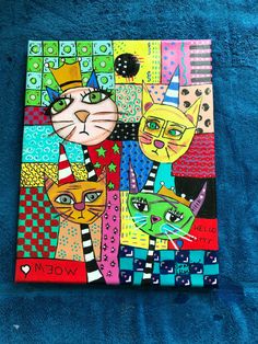 a painting on a blue towel with cats wearing party hats and stars in the background