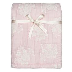 a pink blanket with white flowers on it