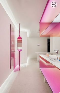 the bathroom is decorated in pink and white with an unusual light fixture hanging from the ceiling