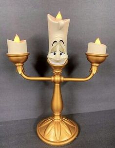 a disney character candle holder with three candles