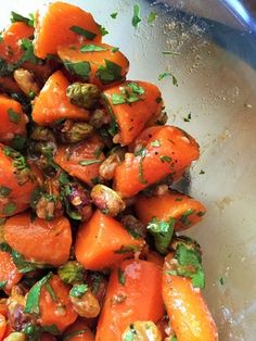 carrots and walnuts are mixed together in a bowl