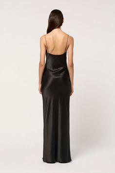 Like liquid silk, the Draped Camisole Slip dress cascades into a full length gown in a simple yet elegant silhouette. Featuring the Michael Lo Sordo signature tailoring, the dress wraps around the body, skimming the bust and hips. Pair with bejewelled sandals for instant poolside glamour, or elevate the look with statement earrings and stilettos. Black Silk Slip Dress, Poolside Glamour, White Halter Dress, Dress Drape, Full Length Gowns, Black Slip Dress, Camisole Dress, Floor Length Gown, Silk Slip Dress