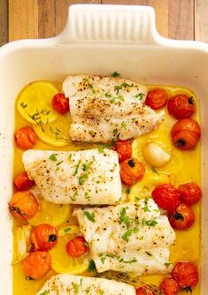 baked fish with tomatoes and herbs in a baking dish