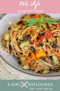 a white bowl filled with pasta and vegetables