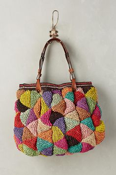 a multicolored purse hanging on the wall