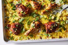 a pan filled with chicken and rice covered in cilantro sauce, garnished with parsley