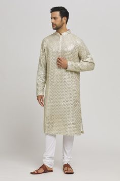 Ivory and golden cotton kurta with mirror and thread embroidery. Comes with churidar. - Aza Fashions Festive Gold Kurta With Mirror Work, Transitional Gold Traditional Wear With Mirror Work, Festive Straight Kurta With Gold Embroidery, Gold Designer Kurta For Transitional Season, Gold Chanderi Kurta With Mirror Work, Festive Kurta With Gold Embroidery For Festivals, Festive Cream Kurta With Gota Work, Gold Embroidered Straight Kurta, Gold Straight Kurta With Mirror Work