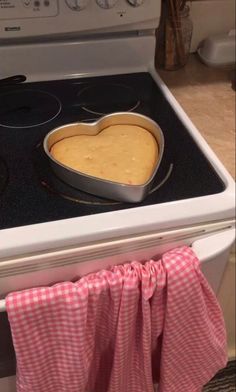 a heart shaped pancake sitting on top of an oven