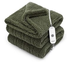 two green towels stacked on top of each other with an electric cord plugged in