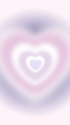 a blurry image of a heart shaped object in pink and blue colors with white center