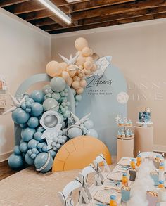 a table set up with balloons and decorations