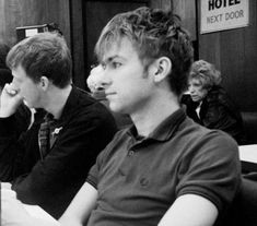 black and white photograph of people sitting at tables